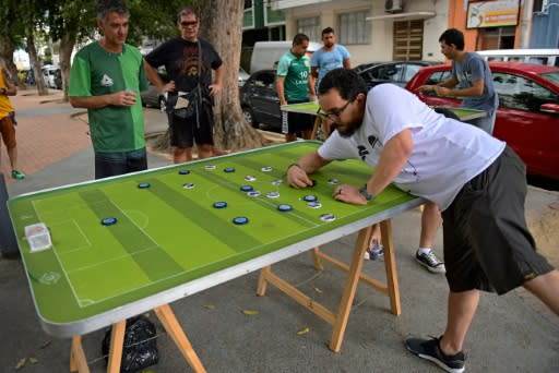 Every weekend, some 20 to 30 people meet in Rio de Janeiro to play button football -- with their customized colorful buttons, inspired by teams around the world and legendary players