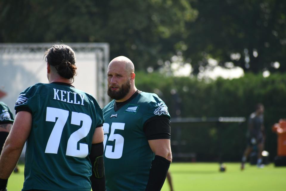 Philadelphia Eagles offensive tackles <a class="link " href="https://sports.yahoo.com/nfl/players/26627" data-i13n="sec:content-canvas;subsec:anchor_text;elm:context_link" data-ylk="slk:Lane Johnson;sec:content-canvas;subsec:anchor_text;elm:context_link;itc:0">Lane Johnson</a> (65) and Dennis Kelly (72) talk during the first day of training camp at the NovaCare Complex in Philadelphia on July 26, 2023.