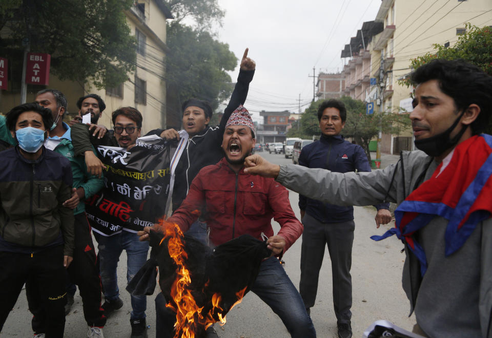 FILE - In this Monday, May 11, 2020, file photo, Nepalese students shout slogans during a protest against the Indian government inaugurating a new road through a disputed territory between India and Nepal, in Kathmandu, Nepal. India’s territorial dispute with its tiny Himalayan neighbour flared up with New Delhi rejecting Nepal’s claim for the second time within a week over an area where India has built a road leading to a revered Hindu pilgrimage site in the Tibetan plateau. In a strongly-worded statement issued late Wednesday, India objected to the Nepalese government releasing a revised official map of Nepal that includes parts of what it claims to be Indian territory. Nepal says the road passes through its territory. (AP Photo/Niranjan Shrestha, File)