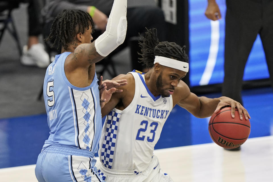 Kentucky's Isaiah Jackson (23) drives past North Carolina's Armando Bacot (5) in the second half of an NCAA college basketball game, Saturday, Dec. 19, 2020, in Cleveland. (AP Photo/Tony Dejak)