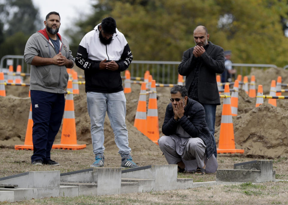 Men praying at the Muslim cemetery in Christchurch. Source: AP