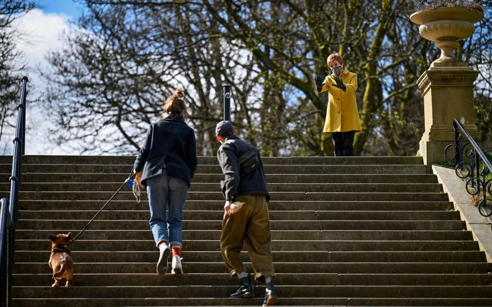 Nicola Sturgeon (right), speaks with members of the public in Queen's Park, Glasgow, during campaigning  - Jeff Mitchell/PA