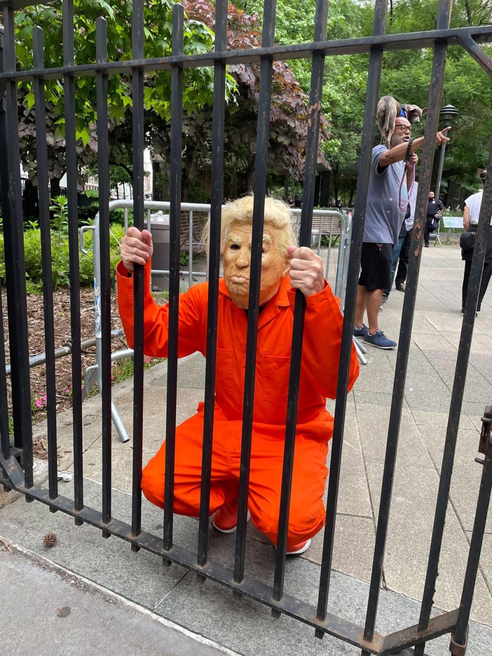 A person dressed up like Donald Trump in a prison jumpsuit.