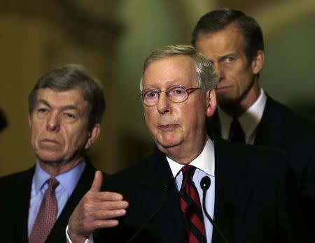 Senate Minority Leader Mitch McConnell (R-KY) (C) speaks to reporters on the current budget negotiations on Capitol Hill in Washington December 9, 2014. REUTERS/Gary Cameron