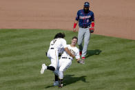 Pittsburgh Pirates' Kevin Newman, center, topples over as Cole Tucker (3) celebrates in front of Minnesota Twins left fielder Marwin Gonzalez (9), after Newman drove him and Bryan Reynolds in with a game winning single in the ninth inning of a baseball game, Thursday, Aug. 6, 2020, in Pittsburgh. The Pirates won 6-5. (AP Photo/Keith Srakocic)