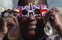 A Royal fan poses outside of Windsor Castle in Windsor Britain April 20, 2016. Britain's Queen Elizabeth celebrates her 90th birthday in Windsor on April 21. REUTERS/Toby Melville