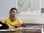 Charlotte Herman, 13, takes notes as teacher Wendy Leighton discusses the Salem witch trials with her students at Monte del Sol Charter School, Friday, Dec. 3, 2021, in Santa Fe, N.M. Leighton is one of dozens of educators who helped draft state's proposed changes to the social studies curriculum, including adding the Sept. 11 attacks and the history of LGBTQ rights. It would increase the focus on ethnic studies in a state where 49 percent of the population is Hispanic, and 11 percent is Indigenous. (AP Photo/Cedar Attanasio)