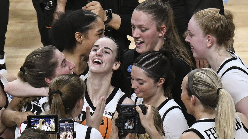 Clark celebrates with her teammates after Iowa defeated LSU in the Elite Eight. - Hans Pennink/AP