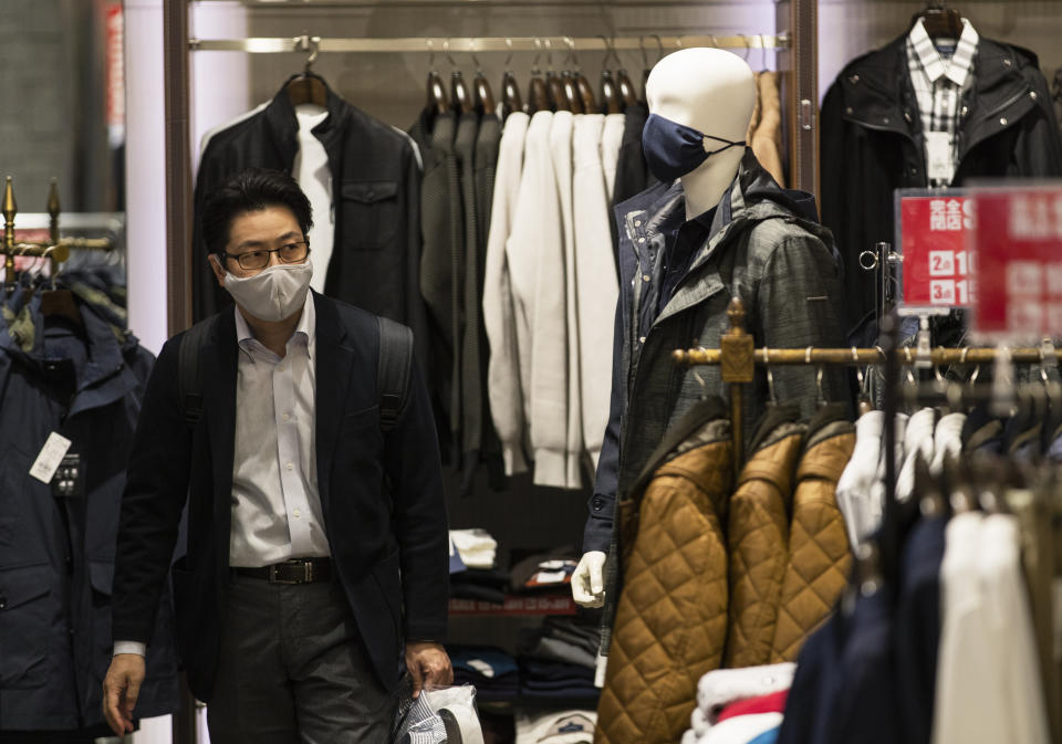 A man wearing a face mask shops around at a clothing store in Tokyo on Thursday, Oct. 29, 2020. (AP Photo/Hiro Komae)