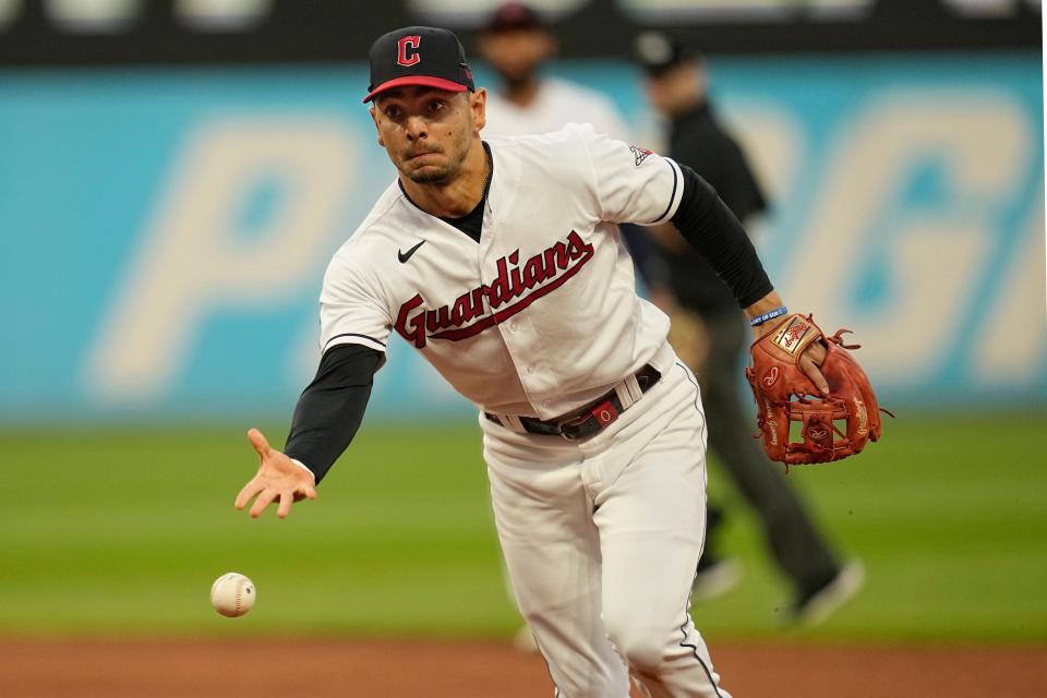 Cleveland Guardians second baseman Andres Gimenez tosses the ball to first baseman Josh Naylor for the out on Kansas City Royals' Drew Waters during the eighth inning of a baseball game Friday, July 7, 2023, in Cleveland. (AP Photo/Sue Ogrocki)