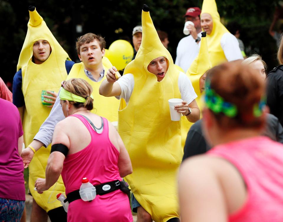 People dressed in banana suits on Gorilla Hill near NW 39 and Shartel encourage runners and hand out bananas April 26, 2015, during the 15th annual Oklahoma City Memorial Marathon.