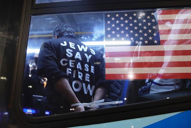 Cuffed protesters arrested during a demonstration calling for a ceasefire amid war between Israel and Hamas at Grand Central Station in New York