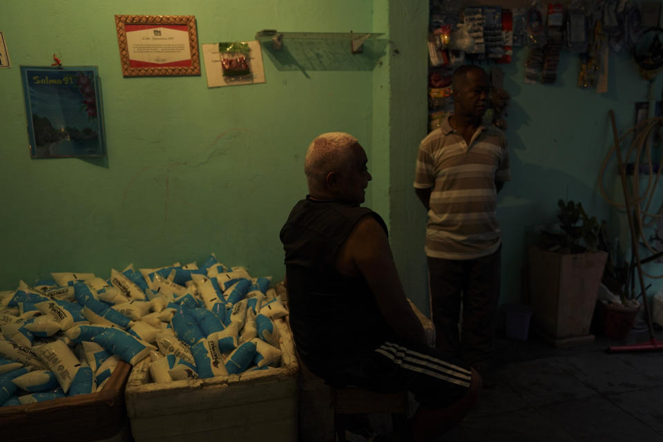 In this May 24, 2019 photo, volunteers get ready to give out free milk distributed by the government to needy families, at the Paraisopolis slum in Sao Paulo, Brazil. The government’s Geographic Institute calculates that 54.8 million Brazilians live in poverty, about 26.5 percent of the population, a level greater than that of India, which has boomed in recent years. (AP Photo/Victor R. Caivano)