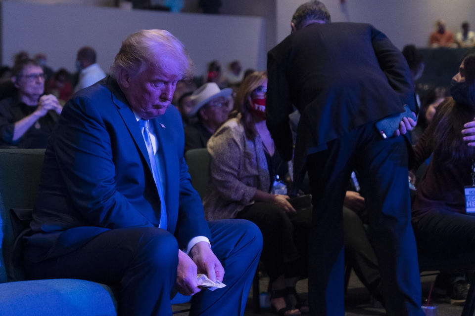 President Donald Trump prepares his offering as he attends church at International Church of Las Vegas, Sunday, Oct. 18, 2020, in Las Vegas, Nev. (AP Photo/Alex Brandon)