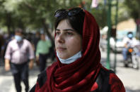 Masoumeh Eftekhari, six months pregnant and strolling through the shop-lined promenades of Tehran’s jam-packed Grand Bazaar, speaks with The Associated Press about the upcoming presidential elections, in Tehran, Iran, Thursday, June 10, 2021. She pointed with astonishment to the skyrocketing prices of baby clothes. (AP Photo/Vahid Salemi)