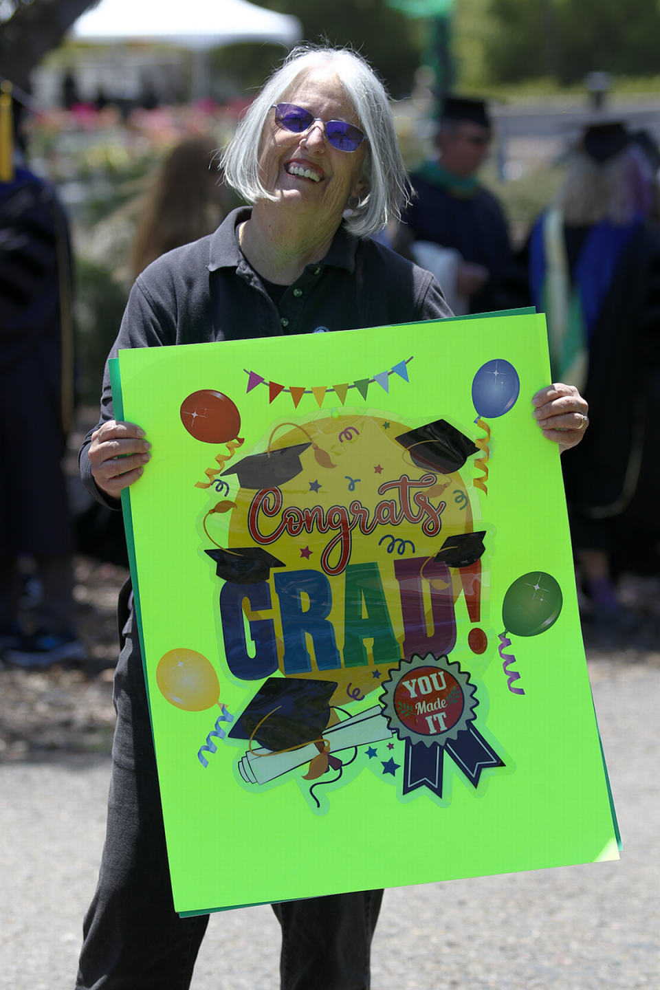 Judy Rittmiller, a DSP program assistant at the North County Cuesta College campus, was part of the cheering section as the students walked to the graduation ceremony on Friday, May 19, 2023.