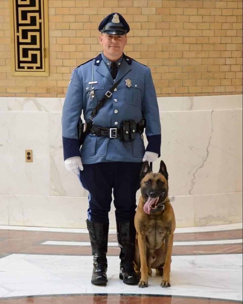 Frankie is seen with his handler, Trooper David Stucenski, at the Statehouse in Boston.