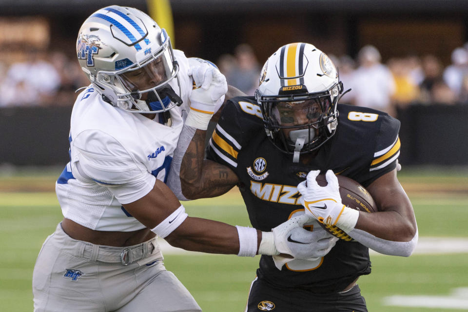 Middle Tennessee safety Jakobe Thomas, left, tackles Missouri running back Nathaniel Peat during the first quarter of an NCAA college football game Saturday, Sept. 9, 2023, in Columbia, Mo. (AP Photo/L.G. Patterson)