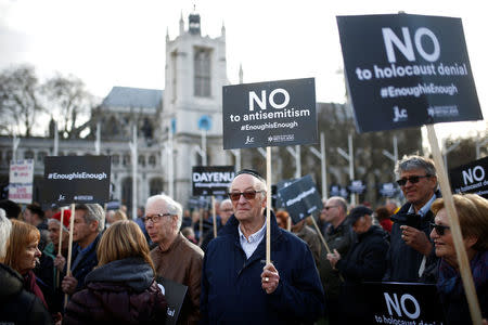 Protesters hold placards and flags during a demonstration, organised by the British Board of Jewish Deputies for those who oppose anti-Semitism, in Parliament Square in London, Britain, March 26, 2018. REUTERS/Henry Nicholls