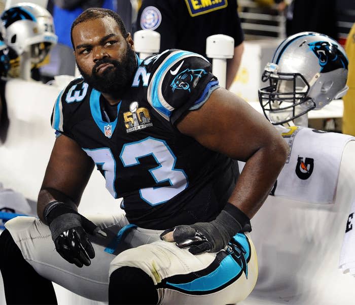 Closeup of Michael Oher sitting on the sidelines during an NFL match