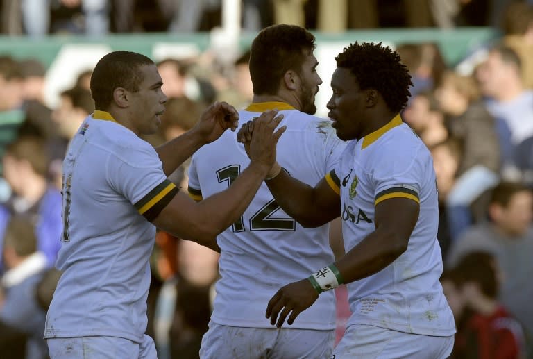 South Africa's Springboks wing Lwazi Mvovo (R) celebrates with teammates Bryan Habana (R) and Damian de Allende after scoring a try against Argentina's Los Pumas during a 2015 Rugby World Cup warm-up match in Buenos Aires, Argentina on August 15, 2015