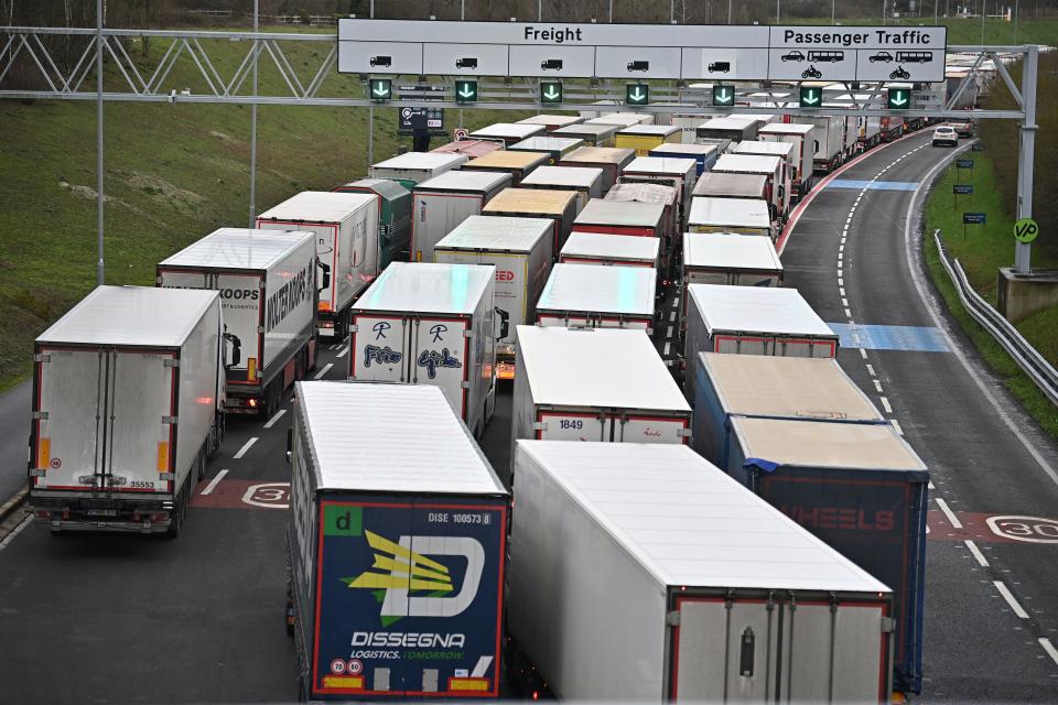 Freight lorries queue at the entrance to the Channel Tunnel Freight terminal in Folkestone on the south coast of England on December 18, 2020. - Questions were asked in the House of Lords on December 17 on the government's state of preparedness for Brexit. UK importers are suffering from delays at Felixstowe and Southampton and there are fears of major delays at Dover from the new year. (Photo by Ben STANSALL / AFP) (Photo by BEN STANSALL/AFP via Getty Images)