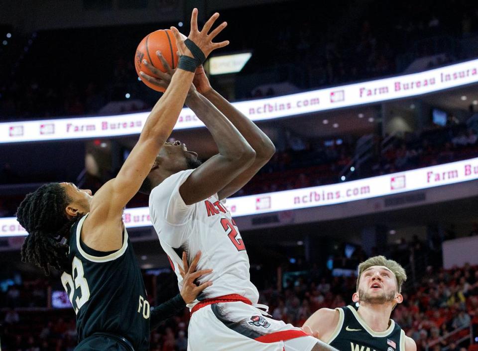 N.C. State’s Mohamed Diarra drives to the basket between Wake Forest’s Hunter Sallis and Andrew Carr during the first half of the Wolfpack’s game at PNC Arena on Tuesday, Jan. 16, 2024, in Raleigh, N.C.