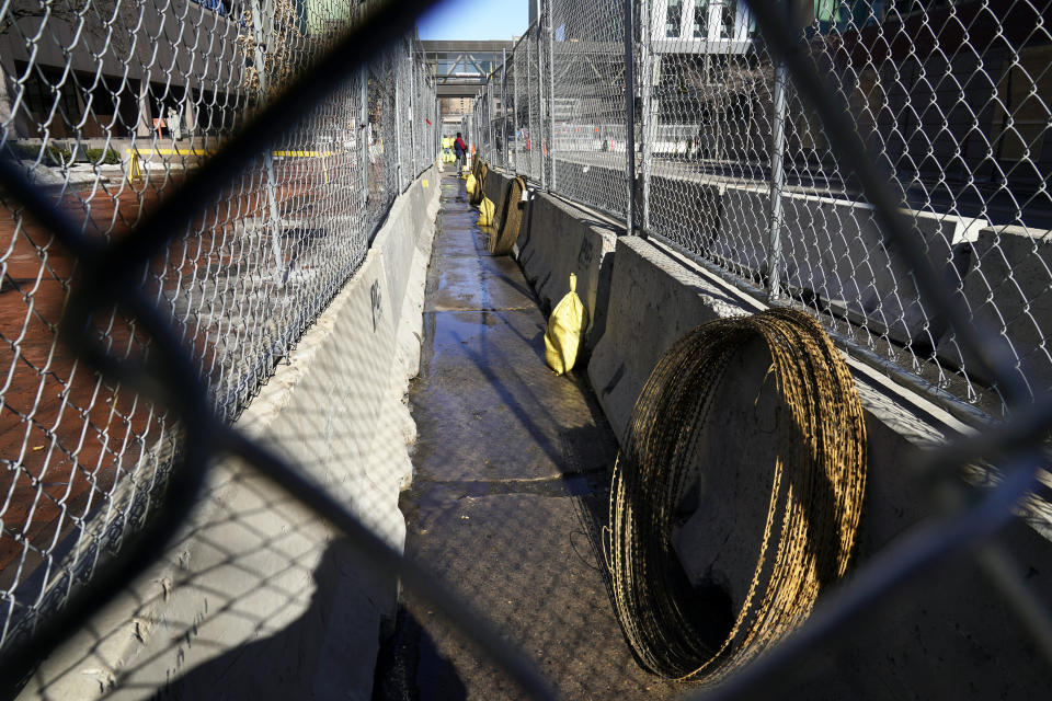 Concertina wire sits ready to be installed between fenced barriers outside the Hennepin County Government Center, Wednesday, Feb. 23, 2021 in Minneapolis, as part of security in preparation for the trial of former Minneapolis police officer Derek Chauvin. The trial is slated begin with jury selection on March 8. Chauvin is charged with murder the death of George Floyd during an arrest last May in Minneapolis. (AP Photo/Jim Mone)