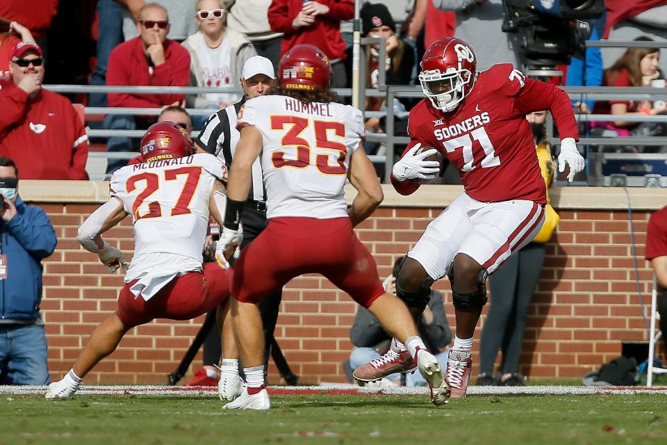 OU's Anton Harrison (71) carries the ball after recovering a fumble during a 28-21 win against Iowa State on Nov. 20, 2021.