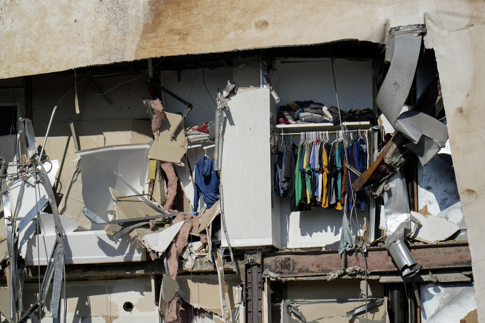 Clothing hanging in an apartment building that partially collapsed on Sunday afternoon can be seen Tuesday, May 30, 2023, in Davenport, Iowa. Five residents of the six-story apartment building that partially collapsed remained unaccounted for Tuesday, and authorities feared at least two of them might be stuck inside rubble that was too dangerous to search. (AP Photo/Erin Hooley)