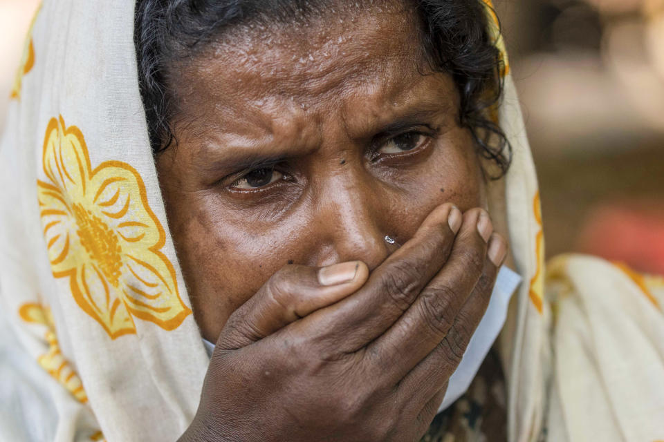 Jenima Mondal kisses a photograph of her son Mamjur Ali Mondal who died in Friday's train accident after receiving his body from the mortuary at the All India Institute of Medical Sciences hospital in Bhubaneswar in the eastern state of Orissa, India, Monday, June 5, 2023. Families of the victims of India's deadliest train crash in decades filled the hospital on Monday to identify and collect bodies of relatives, as railway officials recommended the country's premier criminal investigating agency to probe the crash that killed 275 people. (AP Photo/Rafiq Maqbool)