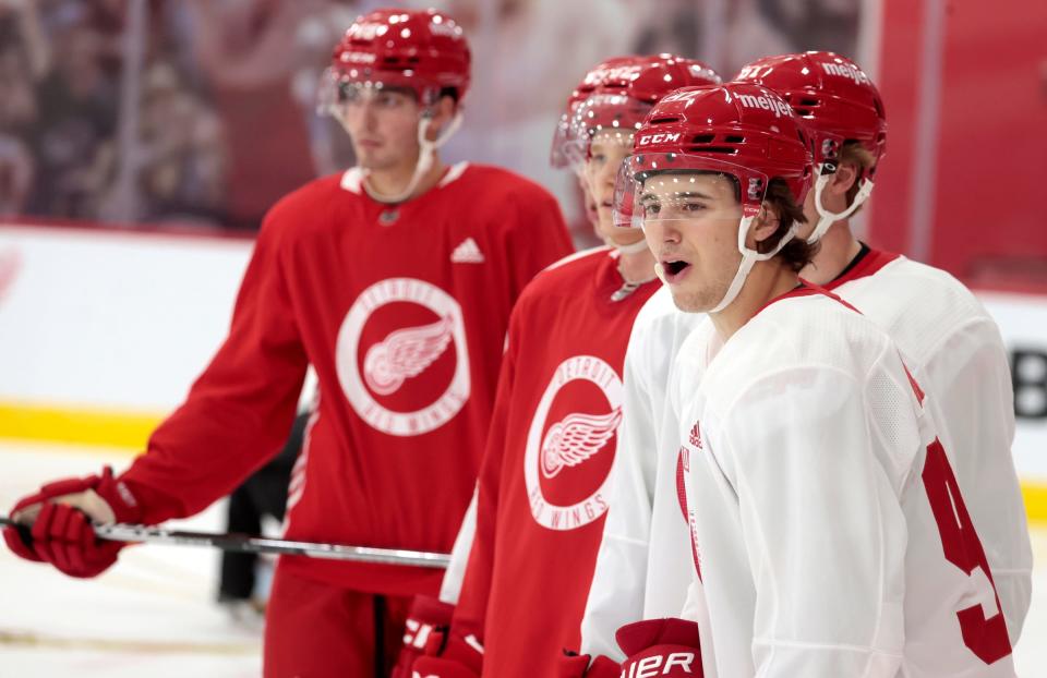 Marco Kasper, right, reacts to a player's move on the ice during the Red Wings development camp at the practice rink at the Little Caesars Arena on Tuesday, July 4, 2023.