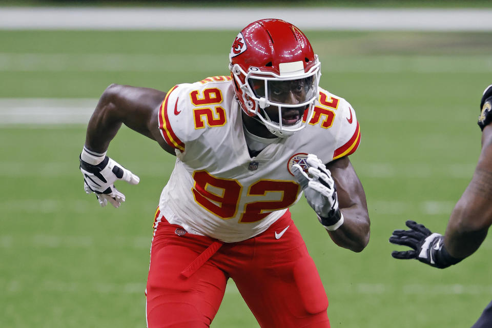 FILE - In this Dec. 20, 2020, file photo, Kansas City Chiefs defensive end Tanoh Kpassagnon (92) rushes during an NFL football game against the New Orleans Saints in New Orleans. Kpassagnon grew up in a home where excellent grades and academic achievements were not only encouraged, they were expected. That's what happens when your mother is a chemist and father an economist, both with doctoral degrees. The bar is set incredibly high. (AP Photo/Tyler Kaufman, File)