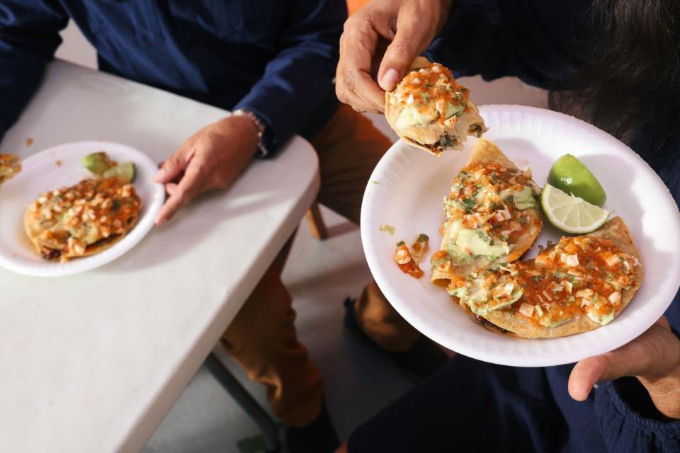 Food editor Daniel Hernandez and food manager Laurie Ochoa sit down for tacos at Mariscos Jalisco