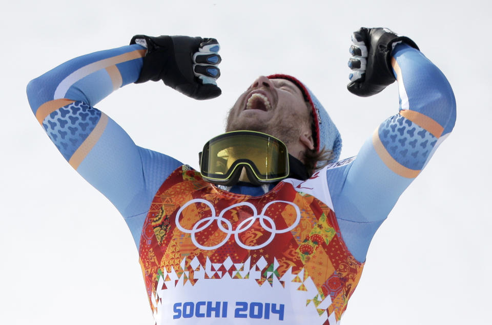 Norway's Kjetil Jansrud celebrates on the podium after winning the gold medal in the men's super-G at the Sochi 2014 Winter Olympics, Sunday, Feb. 16, 2014, in Krasnaya Polyana, Russia. (AP Photo/Charlie Riedel)