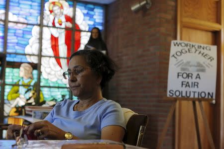 Parishioner Maria Alves knits while sitting vigil at St. Frances Xavier Cabrini Roman Catholic church in Scituate, Massachusetts July 22, 2015. REUTERS/Brian Snyder