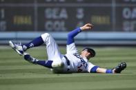 Jul 15, 2018; Los Angeles, CA, USA; Los Angeles Dodgers second baseman Enrique Hernandez (14) slides after catching a fly ball during the ninth inning against the Los Angeles Angels at Dodger Stadium. Mandatory Credit: Kelvin Kuo-USA TODAY Sports