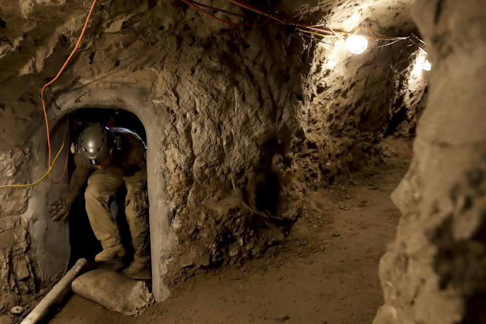 FILE - In this March 6, 2017 photo, a member of the Border Patrol's Border Tunnel Entry Team enters a tunnel spanning the border between San Diego and Tijuana, Mexico, in San Diego. Since 1990, U.S. officials have discovered at least 230 tunnels, most of them running from Mexico into California and Arizona. It's believed smugglers have spent hundreds of thousands of dollars to build the more sophisticated ones with ventilation and lighting. (AP Photo/Gregory Bull, File)