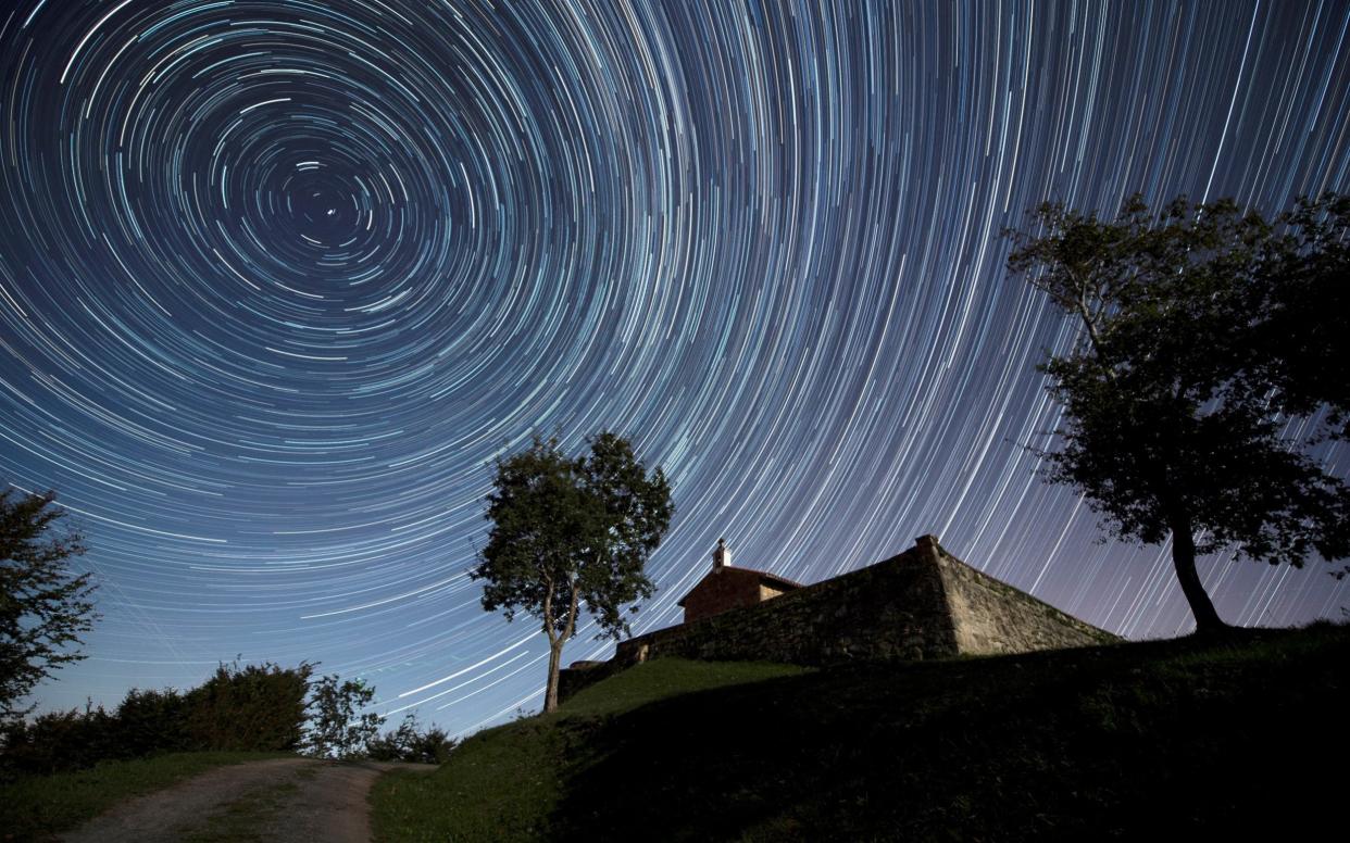 A meteor shower over the chapel of St. Stephen, in the town of Comillas, northern Spain, taken earlier this month - REX