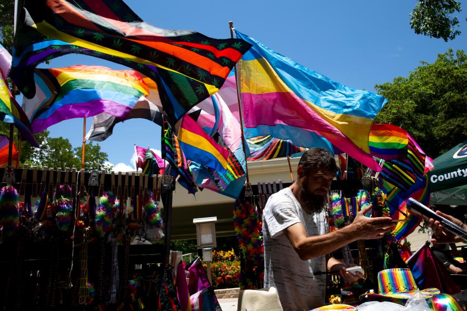 Stefan Terni takes an order at his vendor booth during the 4th Annual Naples Pride Fest, Saturday, July 9, 2022, at Cambier Park in Naples, Fla.