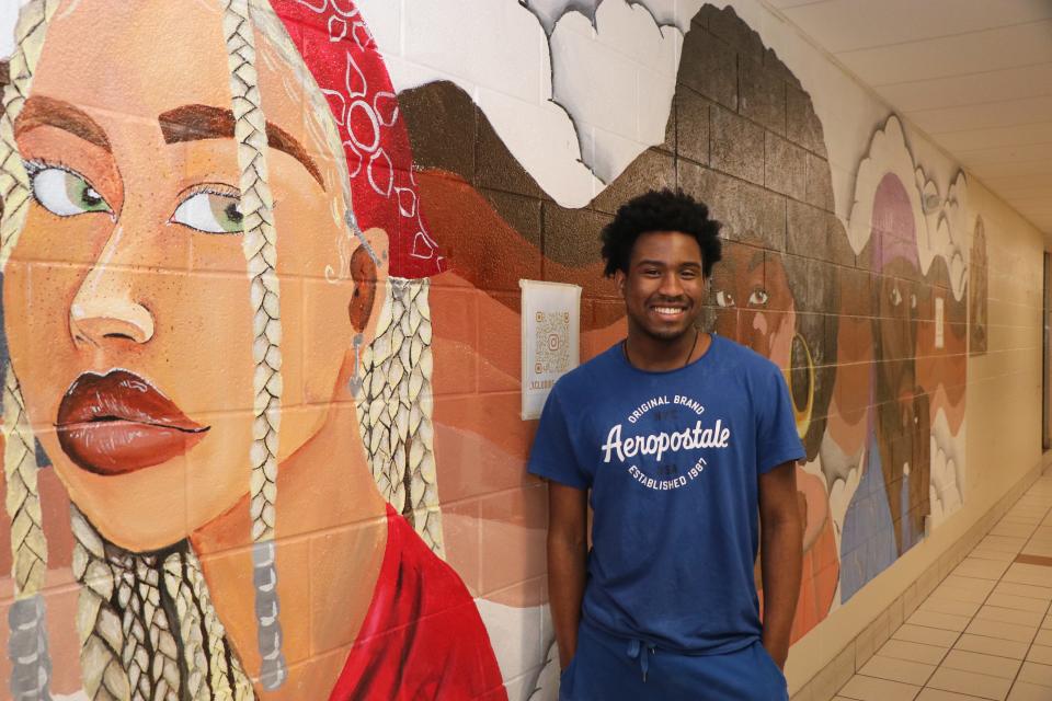 Newburgh Free Academy senior Bryce Knight stands next to the mural he created, called "Melodic Melanin." He's heading to Howard University in the fall to study neuropsychology, with a minor in art.