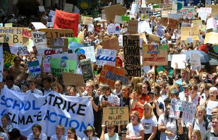 Thousands of children hold placards and chant slogans after they walked out of school in protest against government inaction on climate change in Sydney, Australia, November 30, 2018. AAP/Dan Himbrechts/via REUTERS