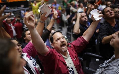 A trader reacts in the S&P futures pit at the CME group in Chicago, September 13, 2012