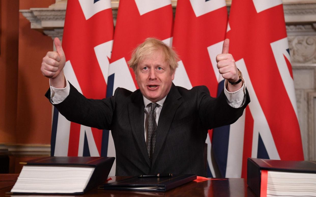 Boris Johnson gives a double thumbs up after signing the Brexit trade deal on December 30 2020 - Leon Neal/AFP