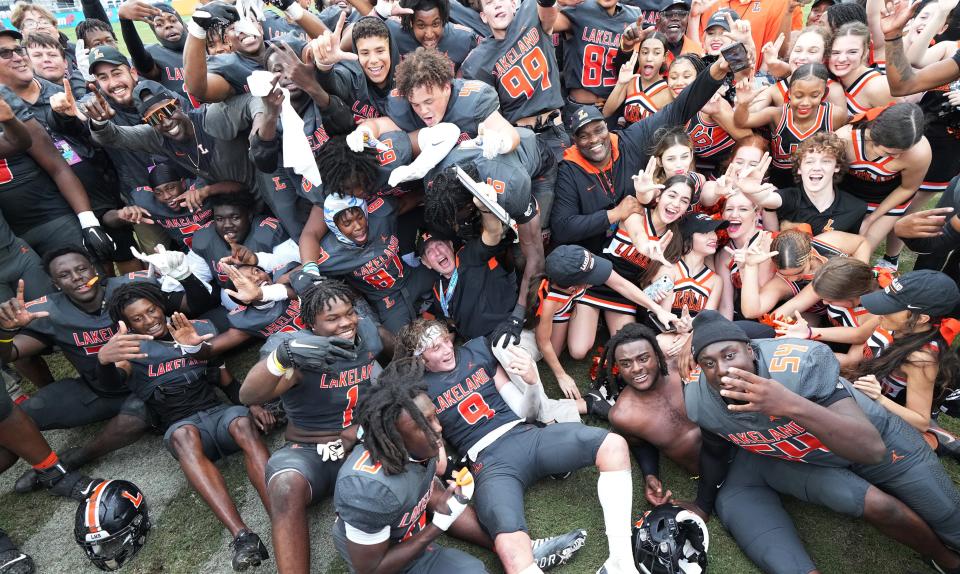 Lakeland head football coach William Castle (center) celebrates winning the Class 4S state championship game over Venice 21-14 with his team at DRV PNK Stadium, Saturday, Dec. 17, 2022 in Fort Lauderdale. 