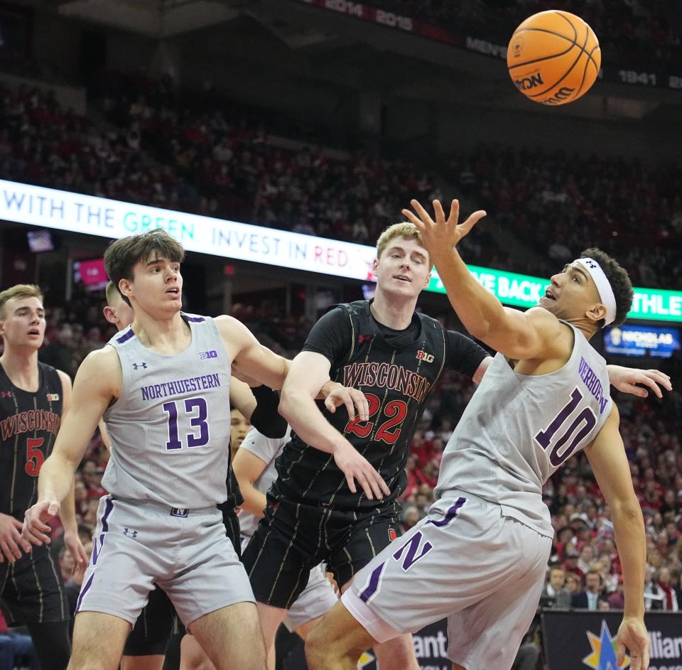 Northwestern forward Tydus Verhoeven (10) beats Wisconsin forward Steven Crowl to a rebound during the first half Sunday at the Kohl Center.