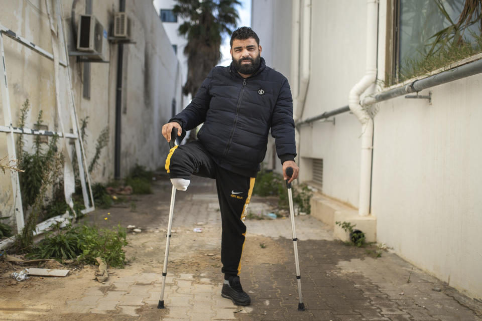 Muslim Gasdallah, 31, a protester who lost a leg after getting shot during Tunisia's democratic uprising 10 years ago poses for a portrait in Tunis, Tunisia, Tuesday, Jan. 12, 2021. (AP Photo/Mosa'ab Elshamy)
