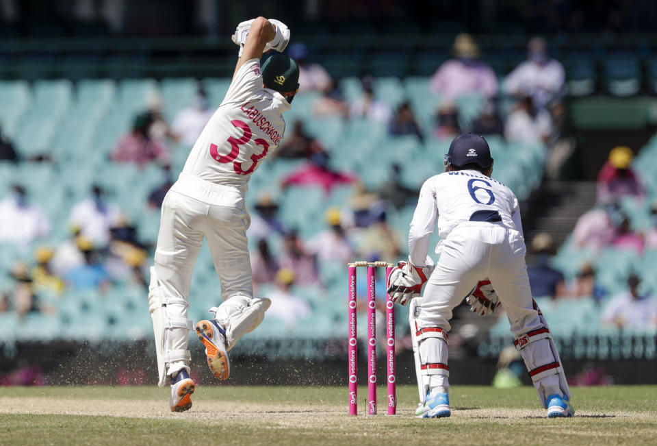 Australia's Marnus Labuschagne, left, bats during play on day four of the third cricket test between India and Australia at the Sydney Cricket Ground, Sydney, Australia, Sunday, Jan. 10, 2021. (AP Photo/Rick Rycroft)