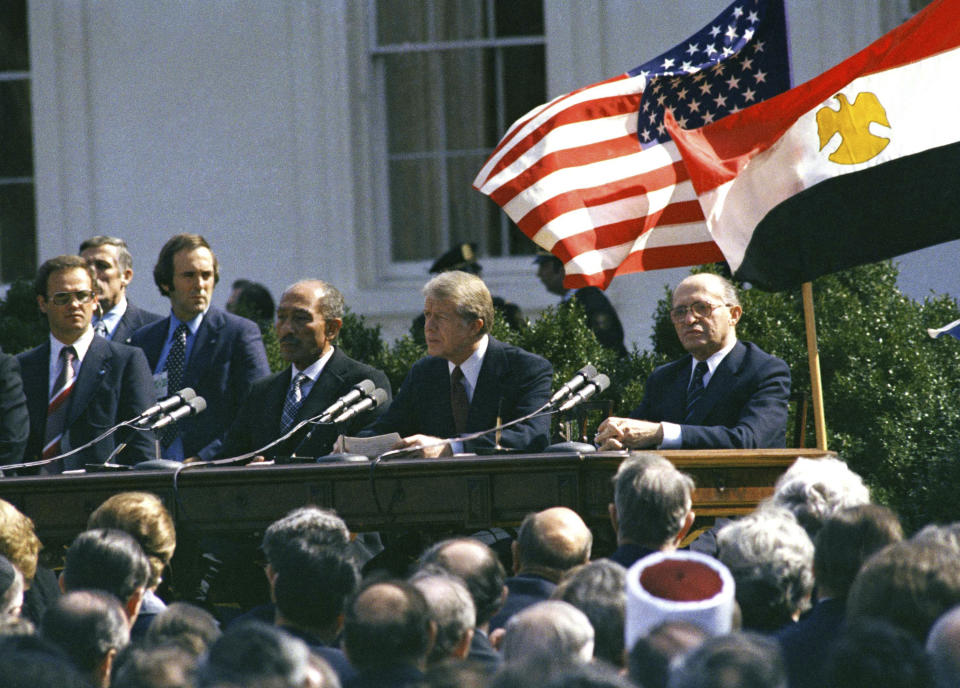 CORRECTS DATE FILE - U.S. President Jimmy Carter, Egyptian President Anwar Sadat and Israeli President Menachem Begin attend the formal ceremony for the Camp David Accords in Washington, D.C., March 26, 1979, designed to bring peace to the Middle East. Egypt has threatened to void its decades-long peace treaty with Israel if Israel begins a large-scale offensive on Rafah, where some 1.4 million Palestinians shelter in densely-packed tent camps on the border with Egypt. (AP Photo, File)