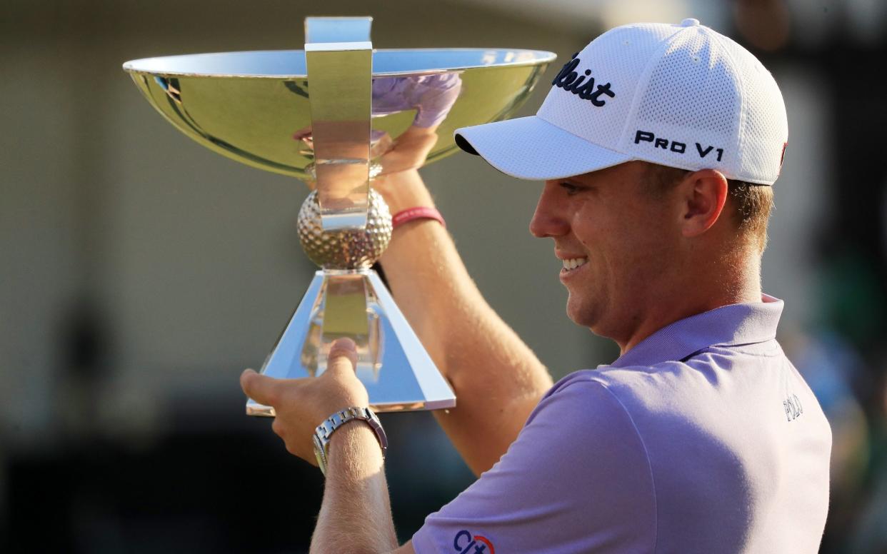 Justin Thomas celebrates with the trophy on the 18th green after winning the FedExCup - Getty Images North America